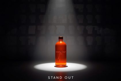 A marketer standing proudly before a glowing neon brand logo surrounded by hearts, stars, and icons, symbolizing memorable branding and customer loyalty.