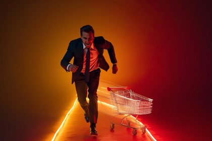 A marketer holding a glowing digital magnet pulling back shopping carts and customer icons, symbolizing recovery from abandoned carts through retargeting and automation.