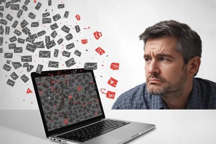 A marketer smiling as glowing personalized emails fly from a laptop and turn into coins and hearts, symbolizing the power of email personalization to increase sales.