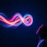 A glowing motion trail forming a brand visual as a marketer watches, symbolizing how animation captures attention and drives digital marketing success.