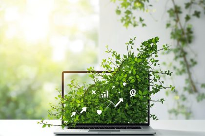 A marketer nurtures a glowing digital plant sprouting from a tablet screen, symbolizing how eco-friendly marketing drives sustainable business growth.