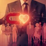 A marketer uses a glowing heart-shaped magnet to attract a diverse audience tagged with demographic data, symbolizing how focus drives deeper marketing engagement.