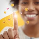 A smiling marketer surrounded by bright emojis, hearts, and shopping icons, symbolizing how humor and fun drive engagement in digital marketing.