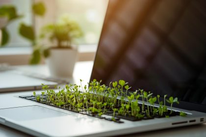 A marketer holds a glowing digital Earth surrounded by eco-icons, symbolizing planet-first digital marketing and sustainable customer engagement.