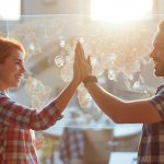 A group of marketers shake hands over a glowing city map with connection points, symbolizing how local partnerships drive digital marketing success.