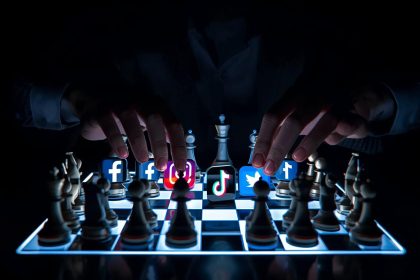 A marketer strategically moves chess pieces shaped like social media icons on a glowing digital chessboard, representing data-driven decision-making in 2025.