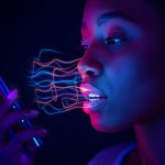 A person speaking into a smartphone with glowing sound waves transforming into search results, symbolizing voice search optimization.