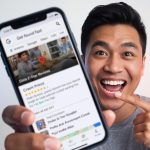 Smiling business owner standing in front of a glowing Google Business Profile dashboard with a verification checkmark, symbolizing trust and visibility in local SEO.