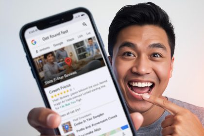 Smiling business owner standing in front of a glowing Google Business Profile dashboard with a verification checkmark, symbolizing trust and visibility in local SEO.