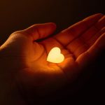 A professional removing a mask to reveal their real face, symbolizing authenticity and trust in purpose-driven branding.