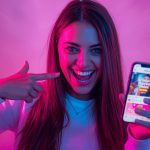 A digital entrepreneur turning social media engagement into sales through shoppable posts and “Buy Now” buttons, symbolizing the rise of social commerce in 2025.