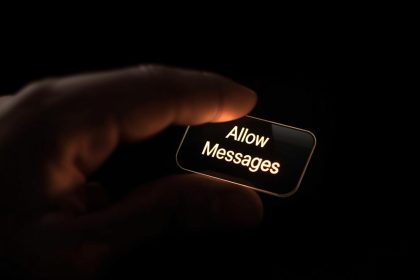 Person pressing “Allow Messages” button on phone screen