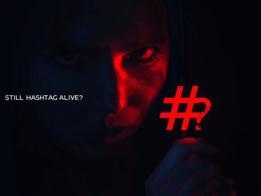 Person holding a large hashtag symbol, looking curious