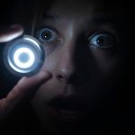 Person pressing trigger button with surprise, visualizing automatio