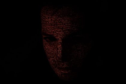 Person’s face half in shadow with glowing data logs and text ‘Who Did What