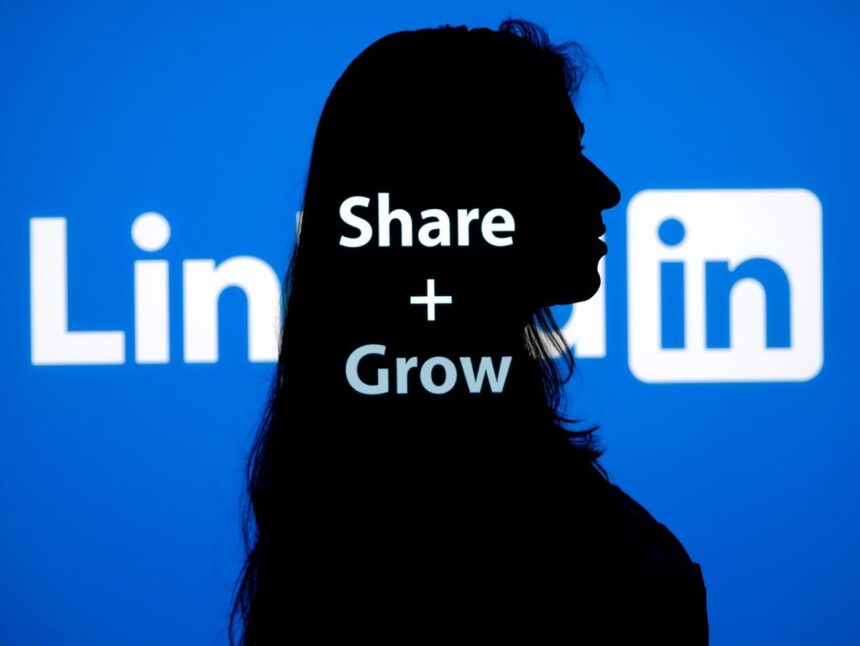 Employee sharing brand message through a LinkedIn megaphone, symbolizing advocacy.