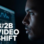 A focused professional reviewing rising LinkedIn video analytics on a bright screen, expressing determination and curiosity about B2B video trends.