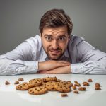A surprised marketing professional pointing at a broken cookie icon and a rising data chart: tracking and attribution in the post-cookie world.