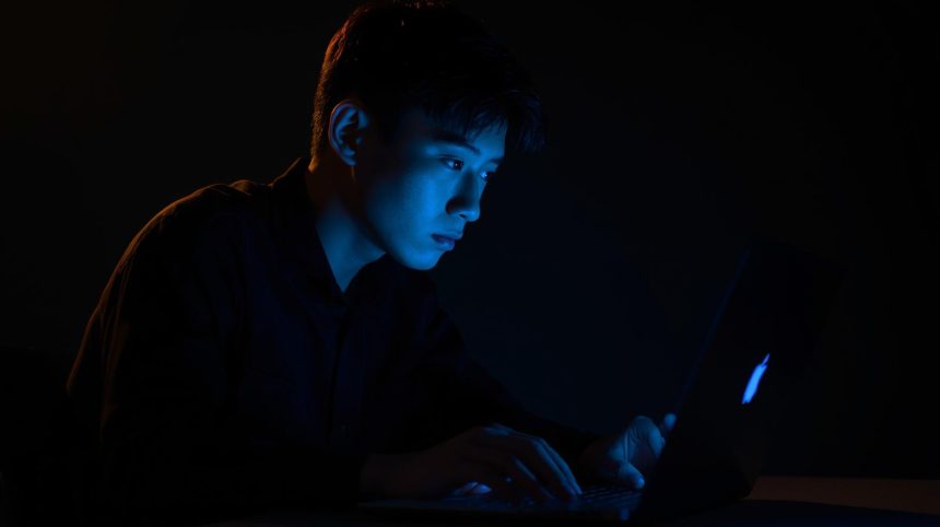 Person with a bold, expressive face illuminated by neon lights, pointing upward with confidence, symbolizing the power of a Social Media Micro-Branding Strategy.