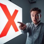 Surprised marketer pointing at a laptop with clean charts, representing sustainable marketing strategies and reduced digital waste.