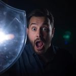 Person reacting with surprise while blocking spam icons, symbolizing community reputation systems and trust control.